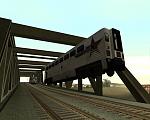 I ran the train a bit to fast and de-railed it. In the process one of the cars got caught on the top of the bridge and was suspended in air. From GTA San Andreas.