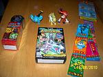 Another Pokémon Cyclone DP dice game, Shinx figure, weird Jolteon figure, Infernape figure, stickers, gum, and keychains. The keychains are called Pokémon Vs. Holder and the box contains the Infernape vs. Luxray one.