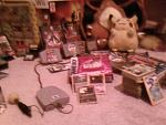 Some special cards, stacks of cards, pokemon plushes, GCN pokemon games, N64 Pokemon games