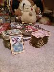 Pokemon game strategy guides(I know, I'm teh cheap) and another view of the stacks of Pokemon Cards(and the Suicune promo from the movie 4EVER!