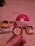 My 2 Pokemon Pikachus, a LED filled Pokeball game(doubles as an actual Pokeball! I'd let the Floatzel out so you could see it, but it's got a Shy nature and doesn't want to take pictures D=), and my Pokemon G/S Trainers Guide along with the Lugia Token from Pokemon The First Movie