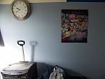 A wall in my room, including a clock with no batteries, a Brawl poster than I've had up for 2+ years, and a laundry hamper.