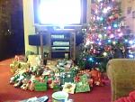 Our pile of presents :). Also, a better view of our Christmas tree.