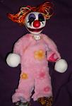Clowny. Clay head and hands, wire frame, plush cloth body, foam and felt feet, string Hair, Painted face.