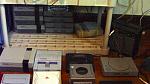 Bottom shelf: NES's, PS1's, and a discolored Super NES that I use for parts.... Oh, and my 10-watt Yamaha guitar amp.