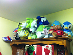 Plushes I keep on a high shelf.
1 Purple Bear(Pinned with a crap ton of Poppies)
1 Brownish Bear
1 Black Beaver
1 Turtwig(With a dino hat eating him :C)
2 Shaymin (Both Varriants)
1 Chikorita
1 Blue Dolphin
2 British shirt wearing Bears
1 Manaphy
1 Piplup
(There's also a Small Hello Kitty and Chimchar behind the Turtwig. Also lol Canada and Yoshi hat... :L )
